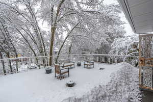 Snowy yard featuring a wooden deck