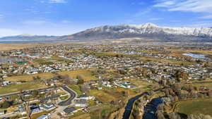 View of property location featuring a water and mountain view and nearby suburban area