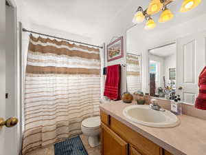 Bathroom with a shower with shower curtain, vanity, and light tile patterned flooring