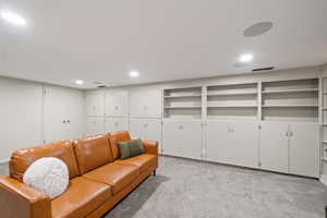 Living room with light carpet and recessed lighting