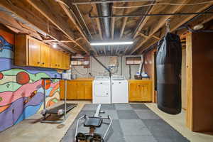 Unfinished basement featuring washer and clothes dryer