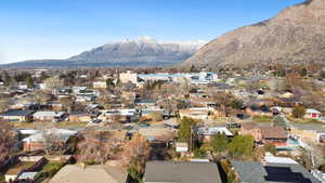 Aerial overview of property's location featuring nearby suburban area and mountains