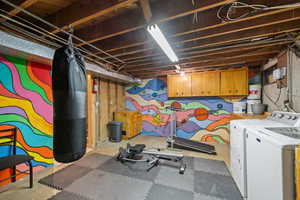 Unfinished below grade area featuring independent washer and dryer