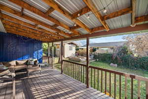 Deck featuring a fenced backyard, a storage unit, and outdoor lounge area