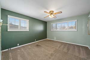 Spare room with carpet floors and ceiling fan