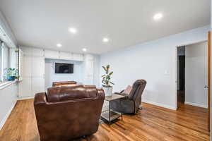 Living area with recessed lighting and wood finished floors