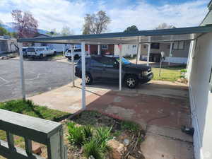 View of parking featuring a carport