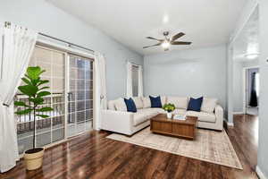 Virtually Staged *Living area featuring wood finished floors and a ceiling fan