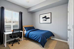 VIRTUALLY STAGED Bedroom #2  featuring carpet flooring, ceiling fan, and an office area