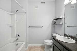 Full bathroom with vanity and shower / bath combination in primary bedroom