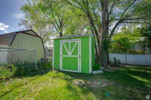 View of shed featuring a fenced backyard
