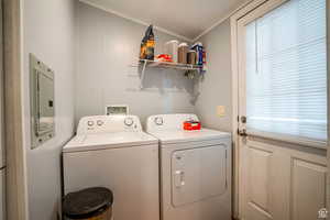 Washroom with electric panel, washer and clothes dryer, and ornamental molding