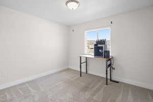 Office featuring baseboards and light colored carpet