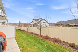 Fenced backyard featuring a residential view