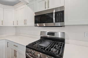 Kitchen with stainless steel appliances and white cabinets