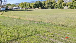 View of yard featuring a rural view and a mountain view