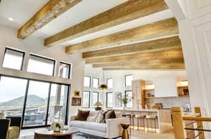 Living room featuring light wood-style flooring and beam ceiling