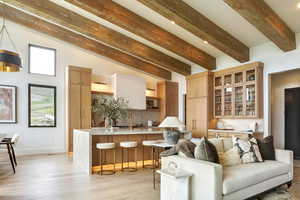 Living room with beamed ceiling and light wood finished floors