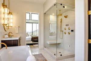Ensuite bathroom with vanity, a shower stall, and a freestanding bath