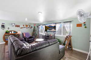 Living area featuring baseboards and wood finished floors