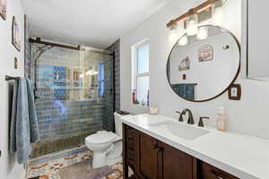 Bathroom featuring vanity, a shower stall, and light tile patterned floors