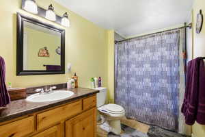 Bathroom featuring vanity, a shower with shower curtain, and light tile patterned flooring