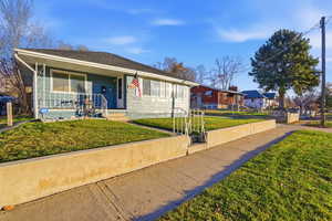 View of front of property with a front lawn and covered porch