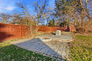 Fenced backyard featuring a patio and an outdoor fire pit