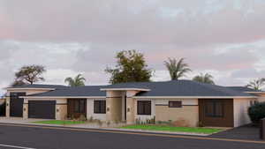View of front of house featuring an attached garage, stucco siding, and roof with shingles