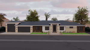 View of front of home featuring a garage, stucco siding, and concrete driveway