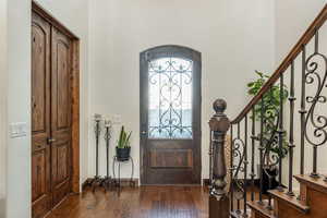 Entryway featuring dark wood-style flooring and baseboards