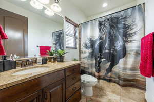 Full bathroom featuring vanity, a shower with curtain, and light tile patterned flooring