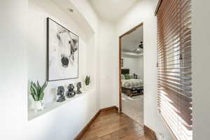 Hall featuring dark wood-style floors and baseboards