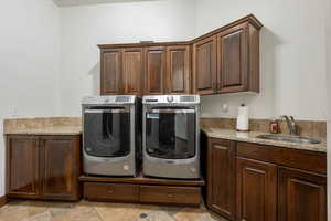 Laundry area featuring washing machine and dryer and cabinet space