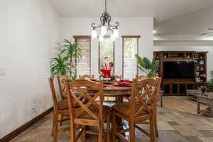 Dining area with stone tile floors and a chandelier