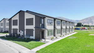 View of property with a residential view and a mountain view