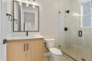 Bathroom with vanity and a shower stall