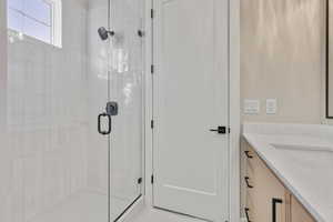 Bathroom featuring vanity and a stall shower