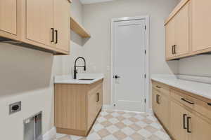 Laundry room with light flooring, cabinet space, and electric dryer hookup