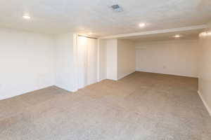 Finished basement featuring light colored carpet and recessed lighting