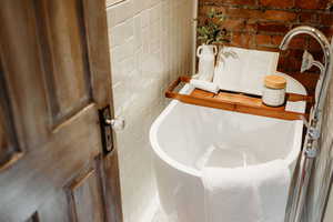 Bathroom with brick wall and a sink