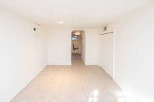 Spare room with arched walkways and recessed lighting