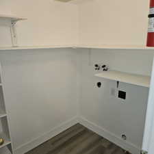 Laundry area with hookup for a washing machine and dark wood-style floors