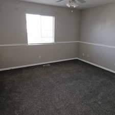 Unfurnished room with dark carpet and ceiling fan