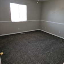 Empty room featuring dark colored carpet and baseboards