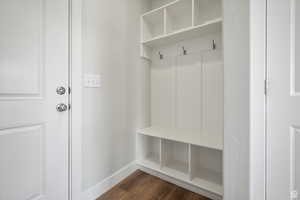 Mudroom with dark wood-style floors and baseboards