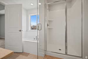 Bathroom with a bath and a shower stall