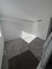 Unfurnished room with carpet flooring and baseboards