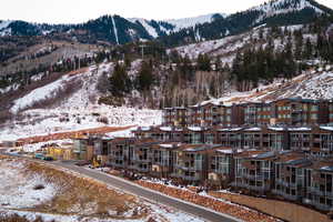 Snowy aerial view with a mountain view and a residential view