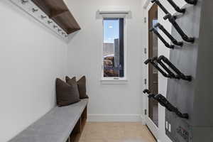 Mudroom featuring baseboards and light tile patterned flooring
